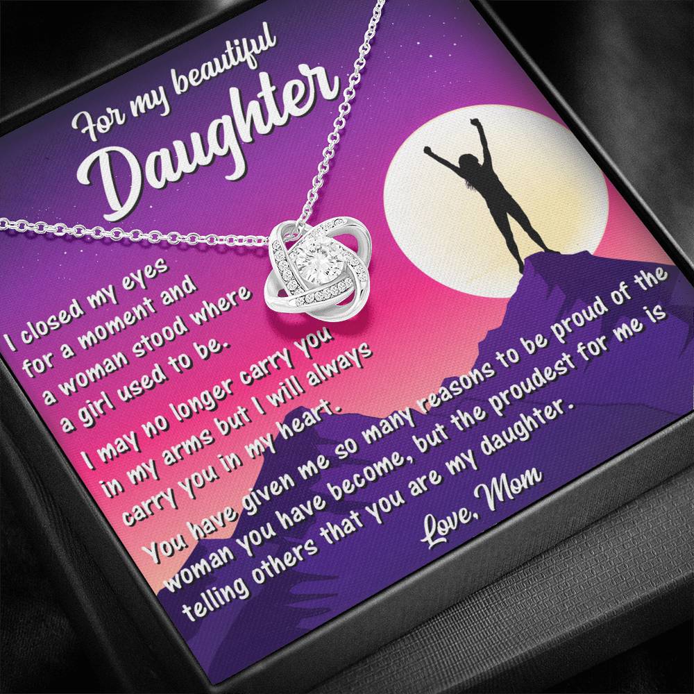 Close-up of Love Knot Necklace pendant with cubic zirconia centerpiece.