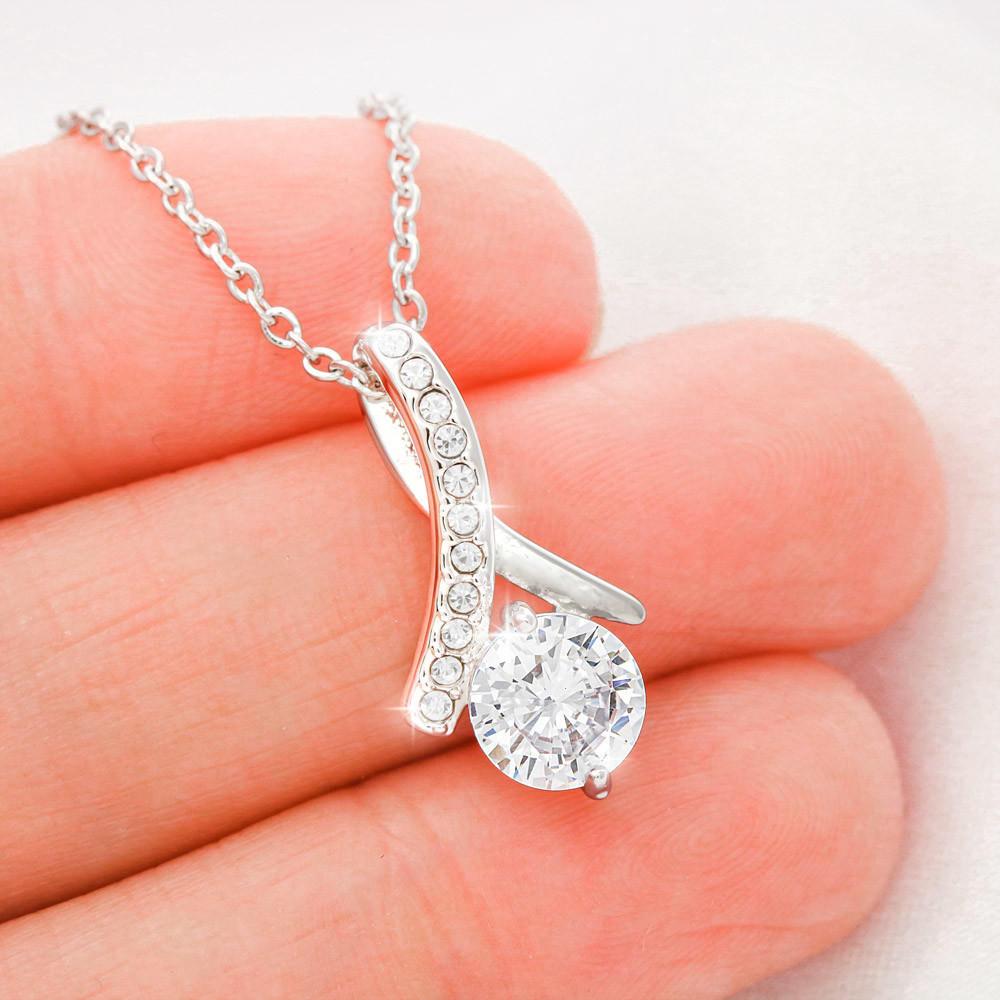 Close-up of daughter's love pendant from father with sparkling cubic zirconia